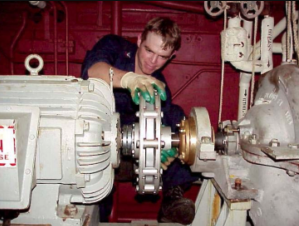 man fixing pump for US navy